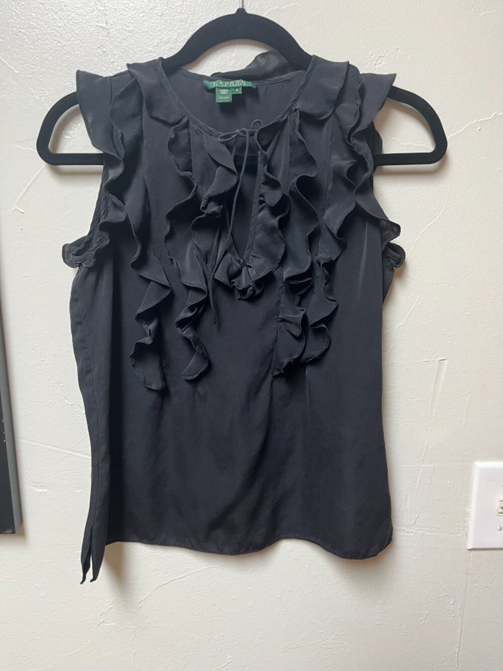 Black sleeveless silk blouse by Ralph Lauren with cascading front ruffle